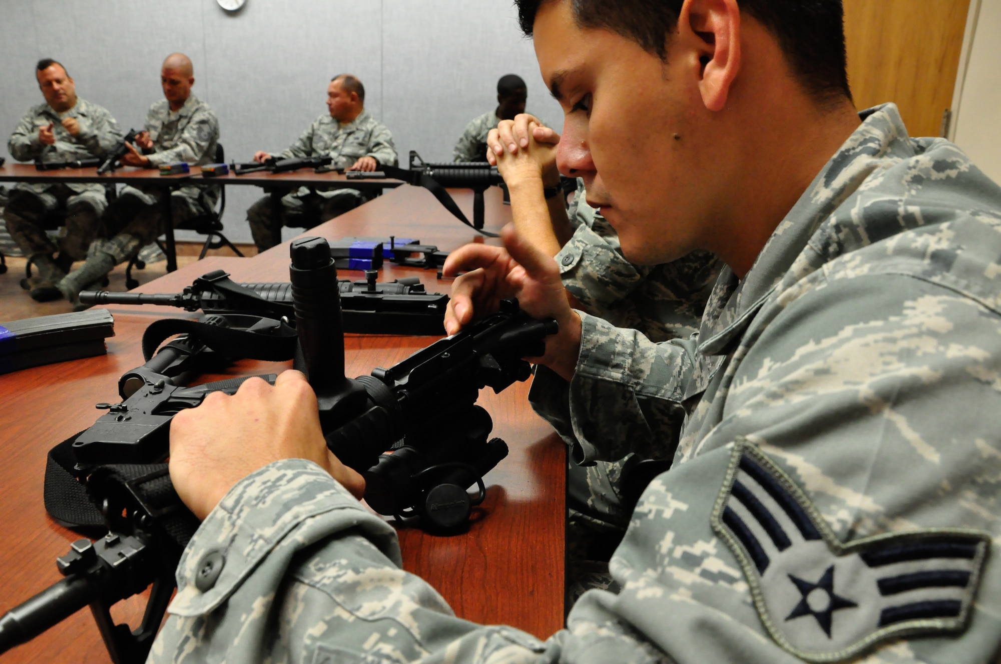 Airmen of the 70th Aerial Port Squadron receive classroom instruction during their M-4 carbine qualification training at Homestead Air Reserve Base’s Combat Arms Training and Maintenance range, Dec. 1. Airmen are scheduled to qualify within the 90 days prior to a deployment or annually, depending on their job, to stay within Air Force regulations. During an evaluation for the M-4, Airmen must hit the target on 17 of 24 rounds to qualify. All told, Airmen fire 192 rounds, to include both practice and evaluation rounds. (U.S. Air Force photo/Tech. Sgt. Robert Gibson)