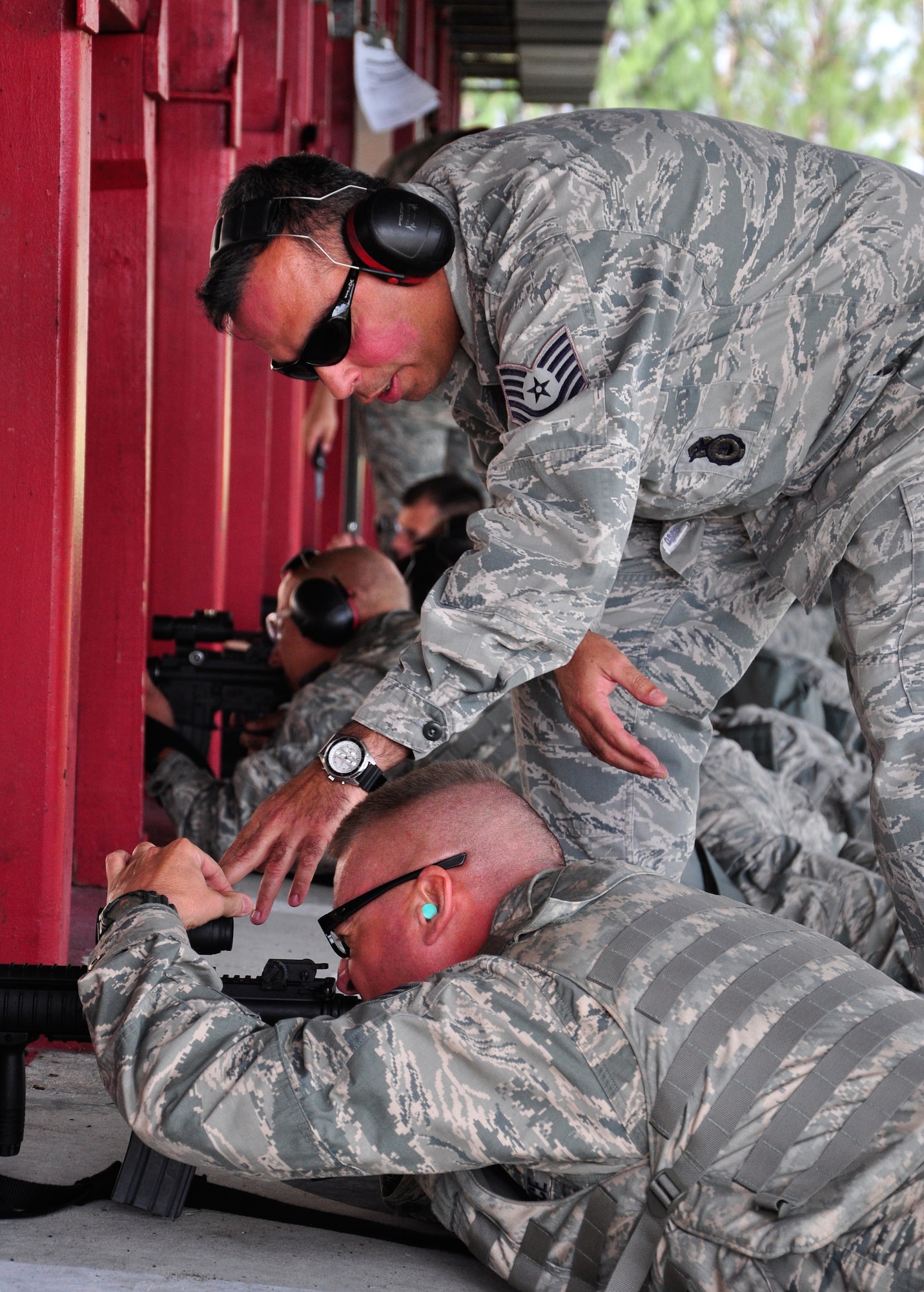 Tech. Sgt. Leon Martin, 482nd Security Forces Squadron Combat Arms Training and Maintenance instructor, gives instruction to Airmen of the 70th Aerial Port Squadron at Homestead Air Reserve Base’s CATM range, Dec. 1. Airmen are scheduled to qualify within the 90 days prior to a deployment or annually, depending on their job, to stay within Air Force regulations. During an evaluation for the M-4, Airmen must hit the target on 17 of 24 rounds to qualify. All told, Airmen fire 192 rounds, to include both practice and evaluation rounds. (U.S. Air Force photo/Tech. Sgt. Robert Gibson)