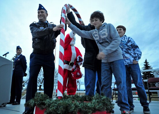 Col. Brian Newberry, 92nd Air Refueling Wing commander, his son’s Mark and Matthew, Nick Snider and Charles Logan, sons of deployed Fairchild Airmen, push the switch to turn on the lights to the base Christmas tree at Fairchild Air Force Base, Wash., Dec. 3, 2012. Members of Fairchild gather to officially start the holiday season by watching the tree lighting ceremony at the base chapel. (U.S. Air Force photo by Airman 1st Class Taylor Curry)