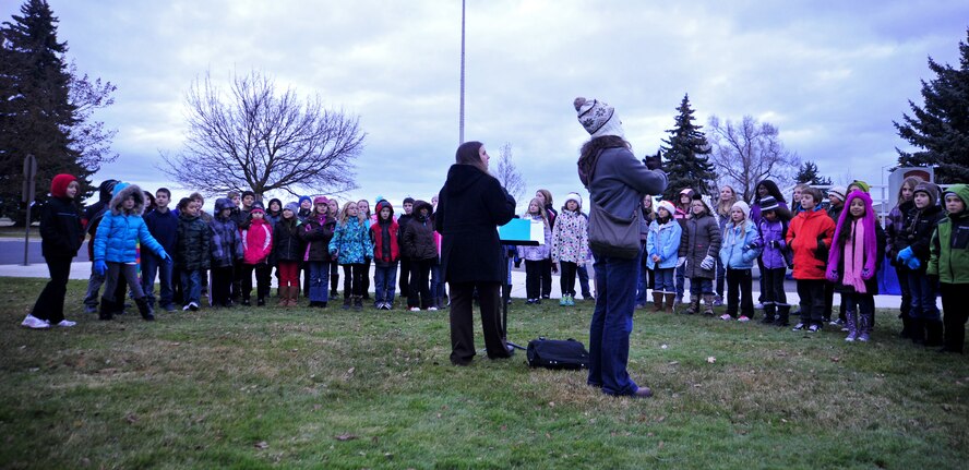 Students from Michael Anderson Elementary School sing Christmas carols at the base tree lighting ceremony at Fairchild Air Force Base, Wash., Dec. 3, 2012. Members of Fairchild gather to officially start the holiday season by watching the tree lighting ceremony at the base chapel. (U.S. Air Force photo by Airman 1st Class Taylor Curry)