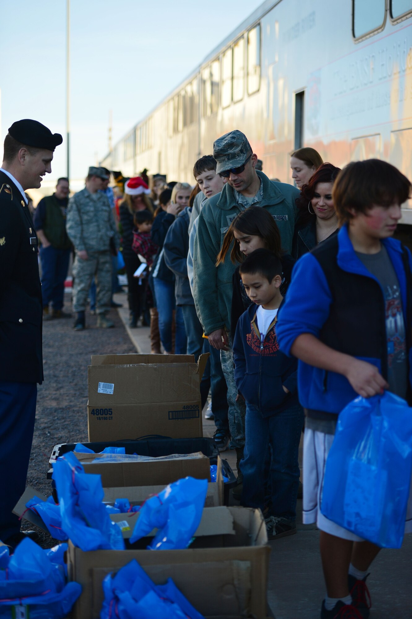 Air Commandos and their families wait in line before boarding the Holiday Express in Clovis, N.M., Dec. 3, 2012. The BNSF Holiday Express train expects to provide rides to more than 3,000 members of military families during its 13-day trip through Texas, Oklahoma, New Mexico, and Arizona. (U.S. Air Force photo/Airman 1st Class Eboni Reece)