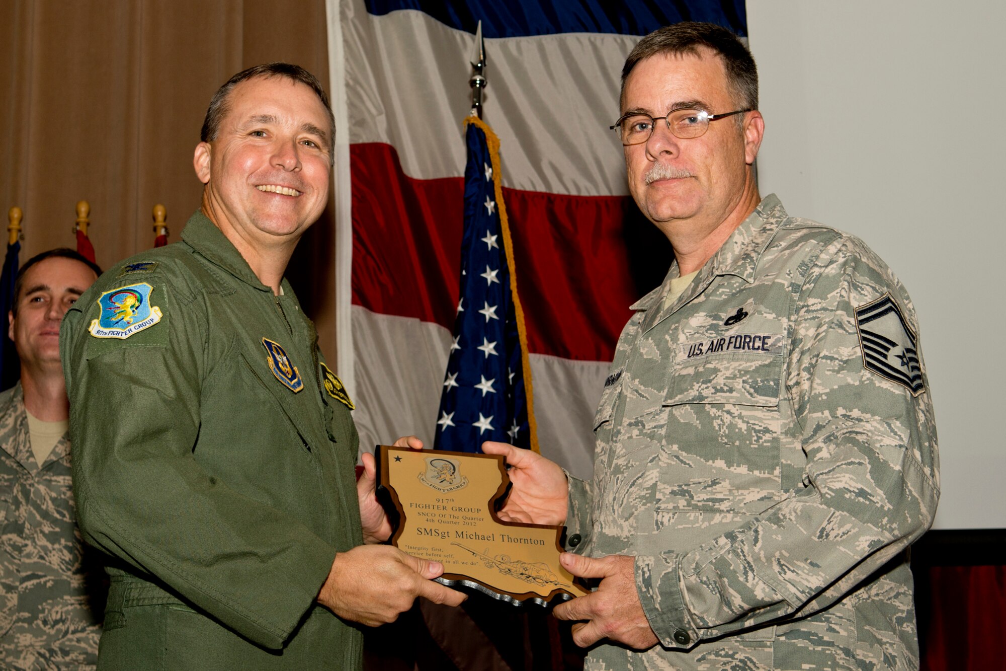 U.S. Air Force Col. John Breazeale, 917th Fighter Group commander, presents the Senior Noncommissioned Officer of the Quarter award to Senior Master Sgt. Michael Thornton, Dec. 2, 2012, Barksdale Air Force Base, La. Thornton received the award for the 4th Quarter of 2012. (U.S. Air Force photo by Master Sgt. Greg Steele/Released)