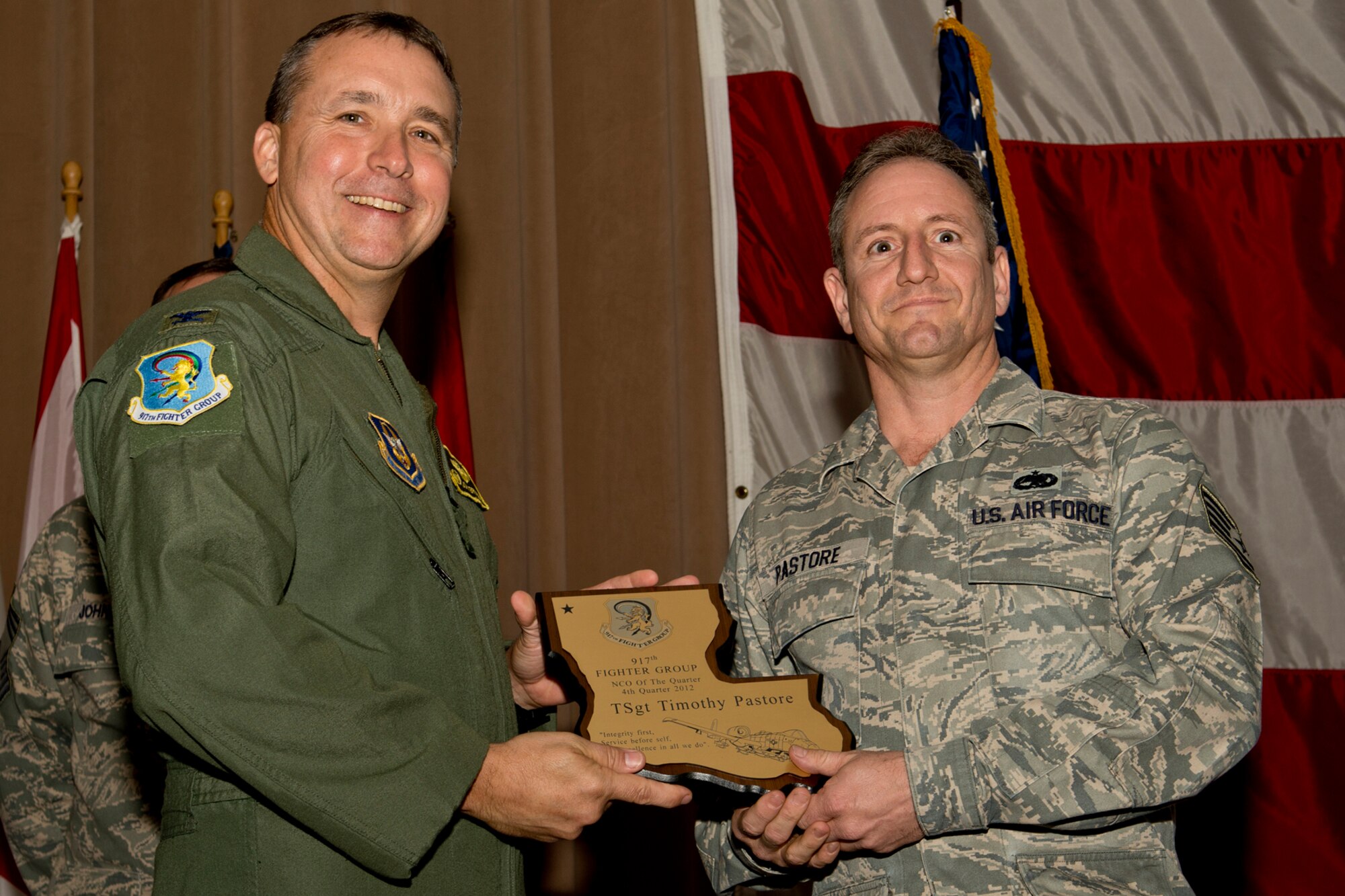 U.S. Air Force Col. John Breazeale, 917th Fighter Group commander, presents the Noncommissioned Officer of the Quarter award to Tech. Sgt. Timothy Pastore, Dec. 2, 2012, Barksdale Air Force Base, La. Pastore received the award for the 4th Quarter of 2012. (U.S. Air Force photo by Master Sgt. Greg Steele/Released)