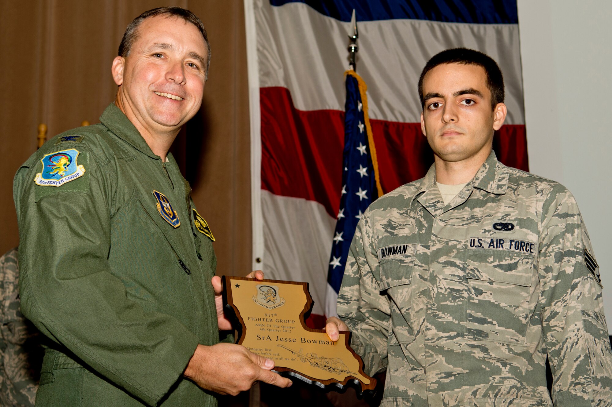 U.S. Air Force Col. John Breazeale, 917th Fighter Group commander, presents the Airman of the Quarter award to Senior Airman Jesse Bowman, Dec. 2, 2012, Barksdale Air Force Base, La. Bowman received the award for the 4th Quarter of 2012. (U.S. Air Force photo by Master Sgt. Greg Steele/Released)