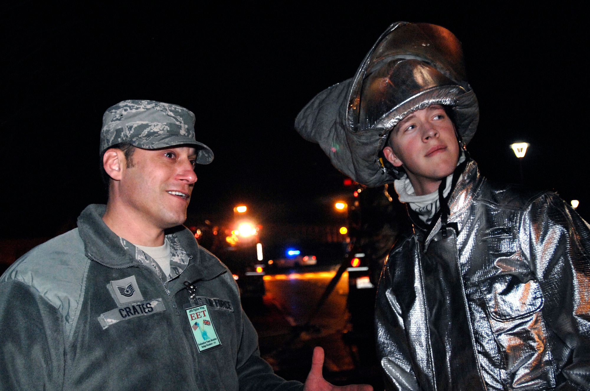 ROYAL AIR FORCE LAKENHEATH, England -- Tech. Sgt. Gerald Crates, 48th Civil Engineer Squadron assistant fire chief of health and safety and native of Orange, Calif., participates as an exercise evaluator during a Phase II Exercise and explains fire ground operation techniques to Airman 1st Class Benjamin Harwood, 48th CES firefighter, Dec. 4, 2012. Crates was nominated for a Liberty Spotlight because he displays the core value of "Service Before Self" (U.S. Air Force photo by Tech. Sgt. Carissa Lee)

