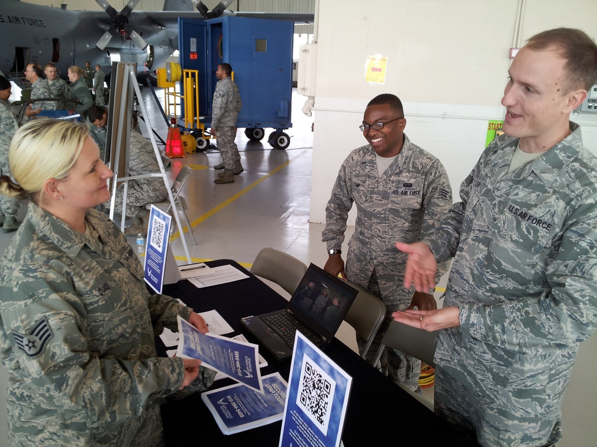 Staff Sgt. Pete Miller and Senior Airman Jomil Camp from the 440th Public Affairs office explain to Staff Sgt. Erin Duke the role of public affairs during Career and Diversity Day, Nov. 4, 2012 at Pope Field, N.C.  Career and Diversity Day was an opportunity for Airmen across Pope Field to learn about career fields from across Pope Field and speak with Airmen in those career fields.  (US Air Force photo by Master Sgt. Steve Staedler, 440 AW/PA)