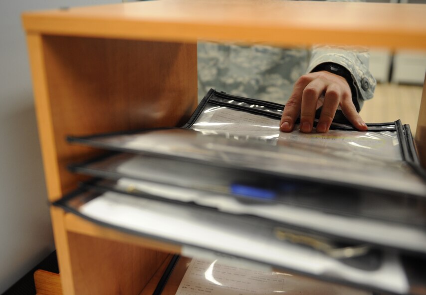 Senior Airman Mitchal Anderson, 2nd Logistics Readiness Squadron Vehicle Management and Analysis journeyman, grabs a work order from an inbox on Barksdale Air Force Base, La., Dec. 3. VMA schedules maintenance and inspections for every government-owned vehicle on base. (U.S. Air Force photo/Airman 1st Class Benjamin Gonsier)