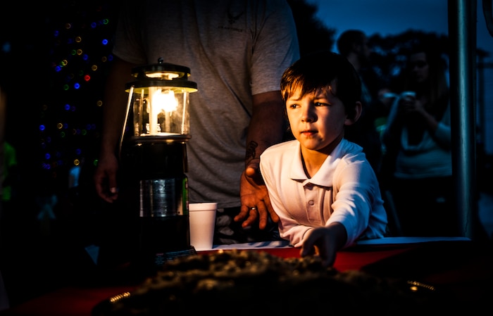 Joshua, age 7, and son of Staff Sgt. Josh Smith, 437th Aircraft Maintenance Squadron crew chief, reaches for a cookie during the 2012 Joint Base Charleston – Air Base Tree Lighting ceremony Dec. 5, 2012. The ceremony included a visit from Santa Claus and the announcing of the Air Base Holiday Card Contest winner. (U.S. Air Force photo/ Senior Airman Dennis Sloan)