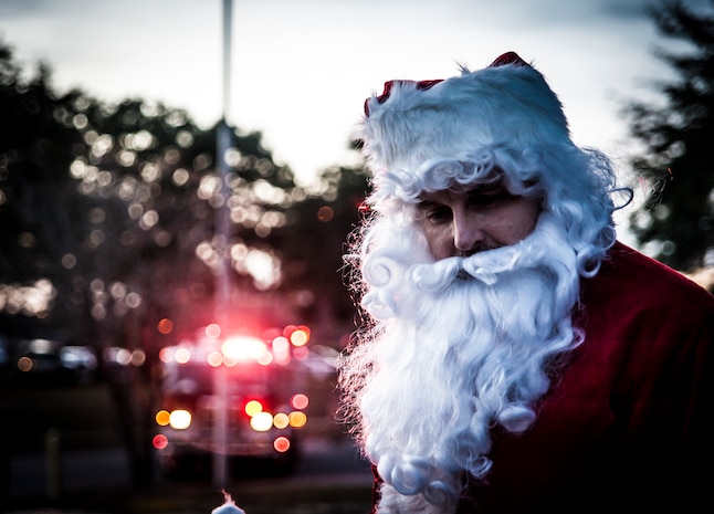 Santa Claus arrives by fire truck at the 2012 Joint Base Charleston – Air Base Tree Lighting ceremony Dec. 5, 2012. Santa greeted children and asked what they wanted for the holidays. (U.S. Air Force photo/ Senior Airman Dennis Sloan)