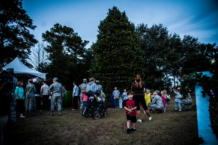 Joint Base Charleston community members gather around the Air Base holiday tree after it was lit Dec. 5, 2012. The ceremony included a visit from Santa Claus and the announcement of the Air Base Holiday Card Contest winner. (U.S. Air Force photo/ Senior Airman Dennis Sloan)