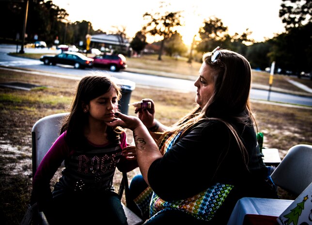 Madison, age 9, and granddaughter of Chaplain (Lt. Col.) Michael Brown, 628th Air Base Wing chaplain, gets her face painted by Melanie Frank Dec. 5, 2012, at the Joint Base Charleston – Air Base Tree Lighting ceremony. The event included food and beverages for all attendees. (U.S. Air Force photo/ Senior Airman Dennis Sloan)