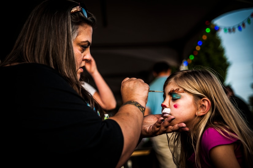 Krysten, age 7, and daughter of Staff Sgt. Bryan Weaver, 628th Communications Squadron, gets her face painted by Melanie Frank, Dec. 5, 2012, at the Joint Base Charleston – Air Base Tree Lighting ceremony. The event included food and beverages for all attendees. (U.S. Air Force photo/ Senior Airman Dennis Sloan)