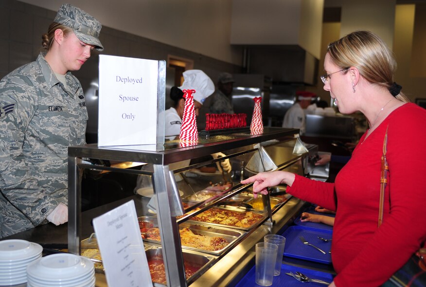 U.S. Air Force Senior Airman Rebecca Elorza, 27th Special Operations Force Support Squadron, serves food during the Hearts Apart deployed spouse dinner at Cannon Air Force Base, N.M., Dec. 4, 2012. The dinner was part of the Hearts Apart program which offers spouses of deployed, temporary duty assignment, or remote tour military members a chance to relax and connect with other families going through the same experience. (U.S. Air Force photo/Airman 1st Class Ericka Engblom)