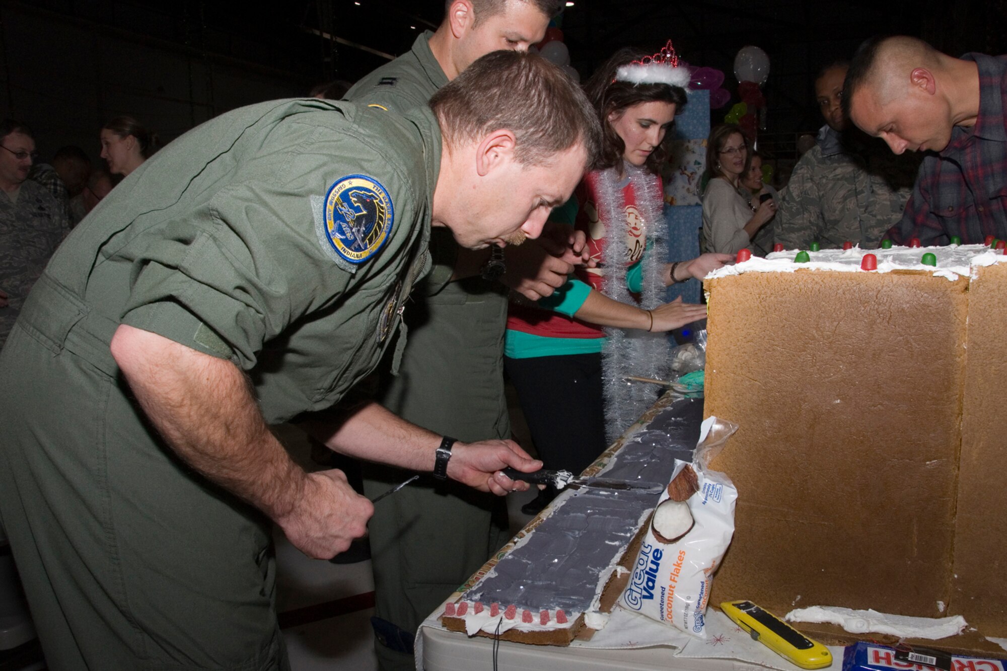 GRISSOM AIR RESERVE BASE, Ind.-- Master Sgt. Paul Sherrod, 72 Air Refueling Squadron boom operator, creates the runway for his gingerbread sculpture.  The gingerbread making contest was just one of several events for Airmen and their families during Grissom?s base Christmas Party Dec. 1. (U.S. Air Force photo/Staff Sgt. Ben Mota)