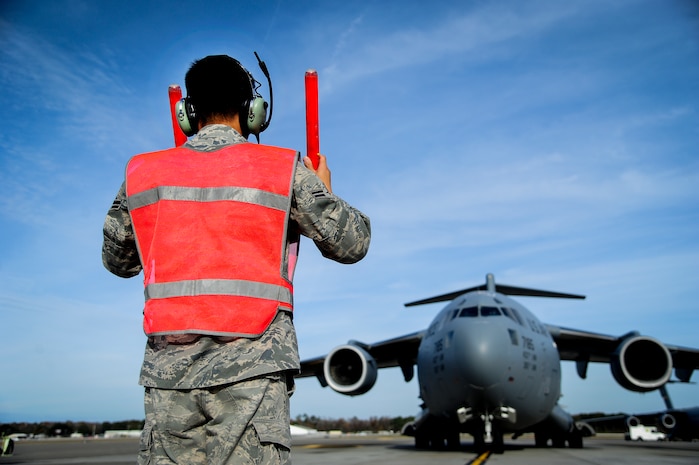 Airman 1st Class Justin Locsin, 437th Aircraft Maintenance Squadron crew chief, marshals a C-17 Globemaster III to its parking spot after landing Dec. 5, 2012, at Joint Base Charleston - Air Base, S.C. Maintainers are responsible for maintaining and repairing all parts of the aircraft. (U.S. Air Force photo/Staff Sgt. Rasheen Douglas)