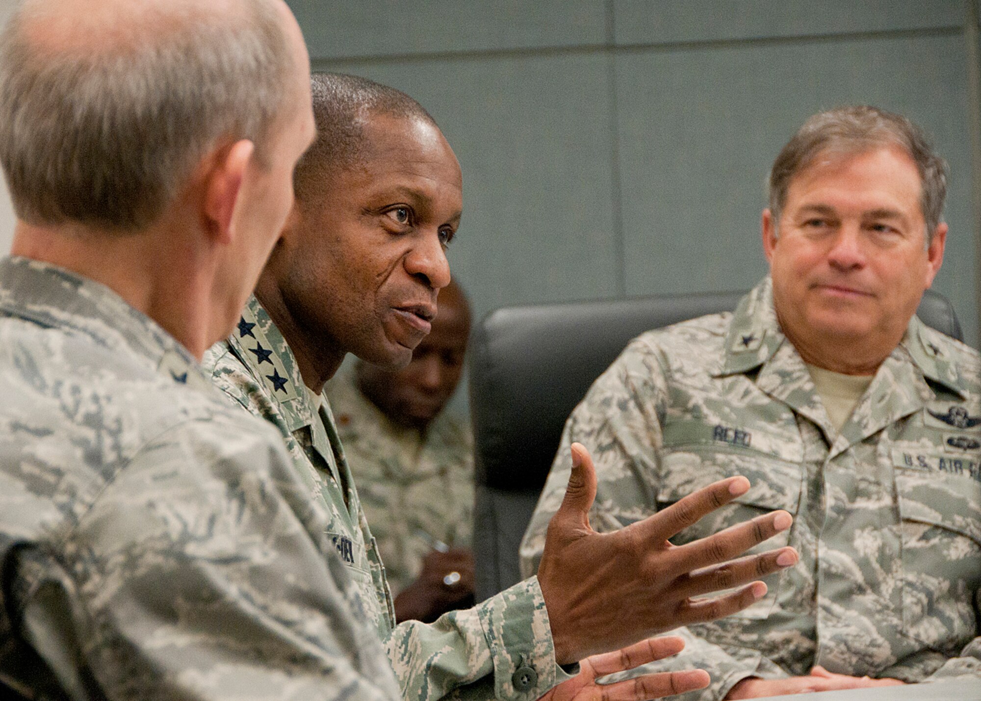 PEASE AIR NATIONAL GUARD BASE, Mass. -- Lt. Gen. Darren McDew, 18th Air Force commander, leans forward to ask a question during a 157th Air Refueling Wing mission briefing in Building 100 Dec. 4 as (left) Maj. Gen. William N. Reddel, The Adjutant General, New Hampshire, and Brig. Gen. Harold E. Reed, 18th Air Force assistant to the commander, look on. Lt. Gen. McDew visited here to meet with Airmen and see first-hand the impact Total Force Integration is having on the mission of the New Hampshire Air National Guard. (National Guard photo by Tech. Sgt. Mark Wyatt/RELEASED)