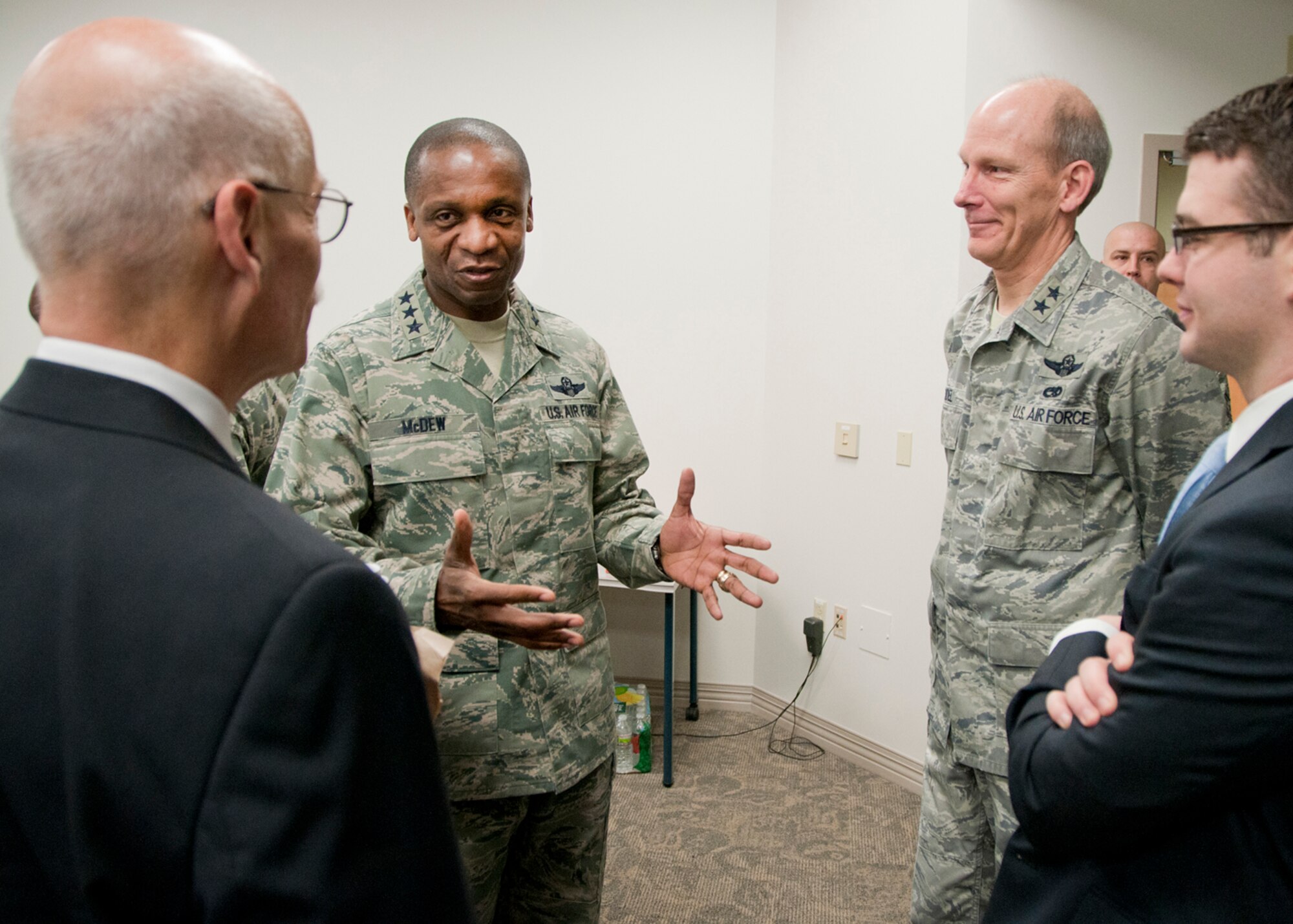 PEASE AIR NATIONAL GUARD BASE, Mass. -- Lt. Gen. Darren McDew, 18th Air Force commander, and Maj. Gen. William N. Reddel, The Adjutant General, New Hampshire, welcome congressional staff members (left) Steve Monier and Patrick Day to a 157th Air Refueling Wing mission briefing during a visit to Building 100 Dec. 4. The 18th Air Force commander visited here to meet with Airmen and see first-hand the impact Total Force Integration is having on the mission of the New Hampshire Air National Guard. (National Guard photo by Tech. Sgt. Mark Wyatt/RELEASED)