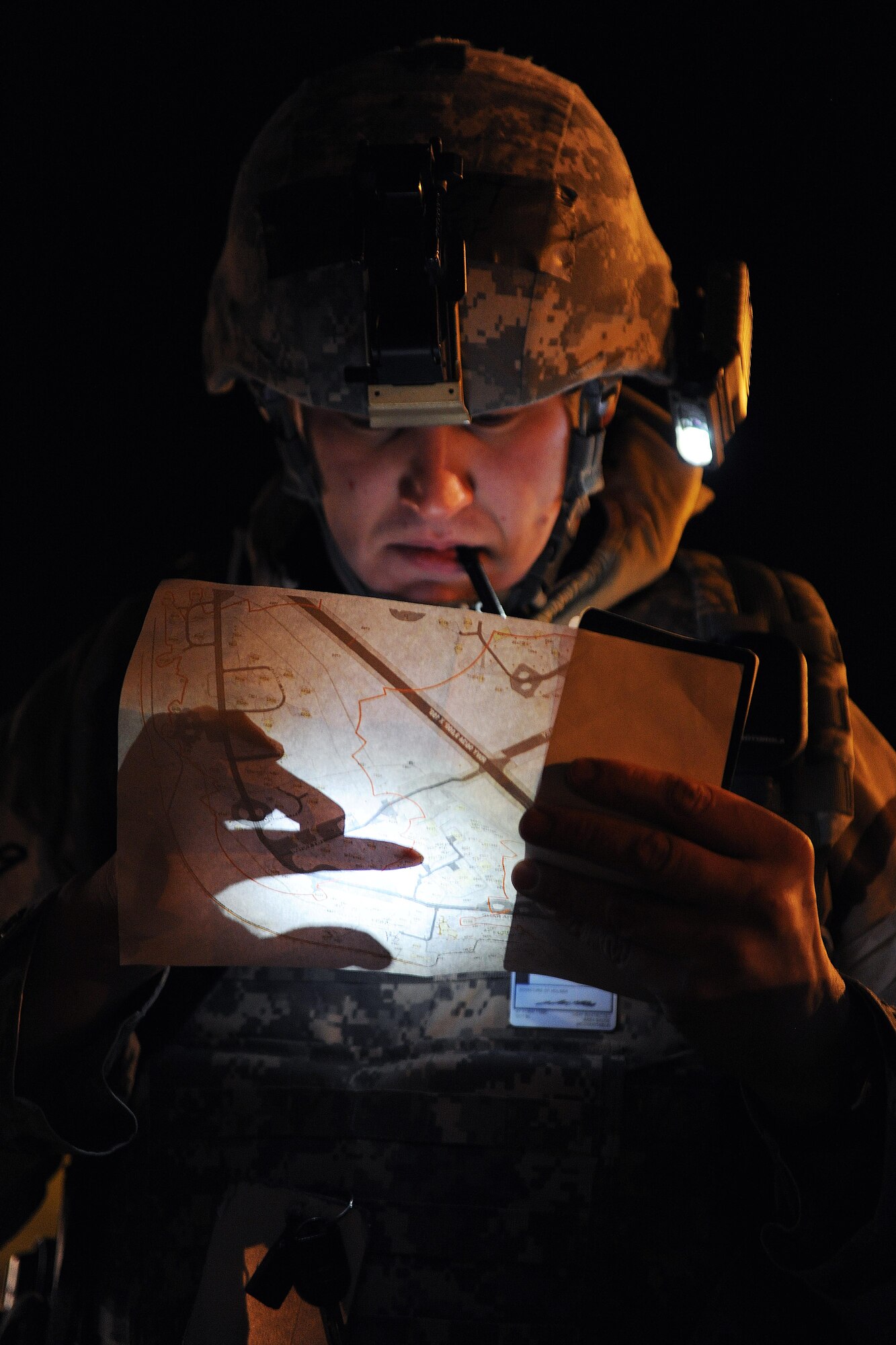 ROYAL AIR FORCE LAKENHEATH, England -- Tech. Sgt. John Petcoff, 48th Security Forces Squadron flight chief, reviews a map during a Phase II Exercise Dec. 5, 2012. The week-long exercise tested combat sortie capabilities of the 48th Fighter Wing to support a NATO contingency operation. (U.S. Air Force photo by Senior Airman Lausanne Morgan)