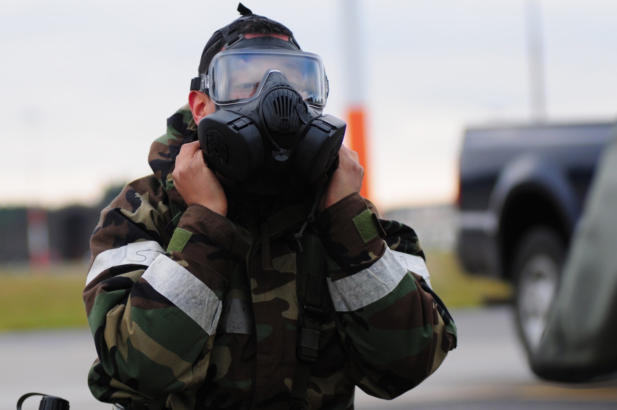 ROYAL AIR FORCE LAKENHEATH, England – Senior Airman Ivan Tello, 48th Aircraft Maintenance Squadron crew chief, removes his gas mask after a simulated vehicle fire during a Phase II Exercise Dec. 5, 2012. The week-long exercise tested 48th Fighter Wing readiness to support NATO contingency operations. (U.S. Air Force photo by Airman 1st Class Cory D. Payne)