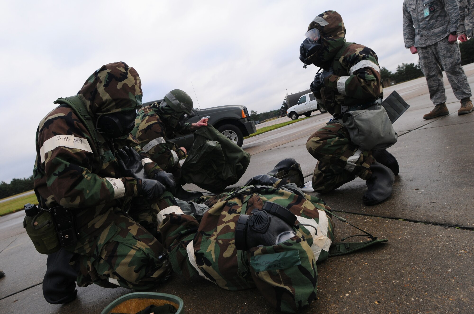 ROYAL AIR FORCE LAKENHEATH, England – Airmen from the 48th Fighter Wing don their Mission Oriented Protective Posture gear while treating a casualty for wounds after a simulated vehicle fire during a Phase II Exercise Dec. 5, 2012. The week-long exercise tested 48th FW readiness to support NATO contingency operations. (U.S. Air Force photo by Airman 1st Class Cory D. Payne)