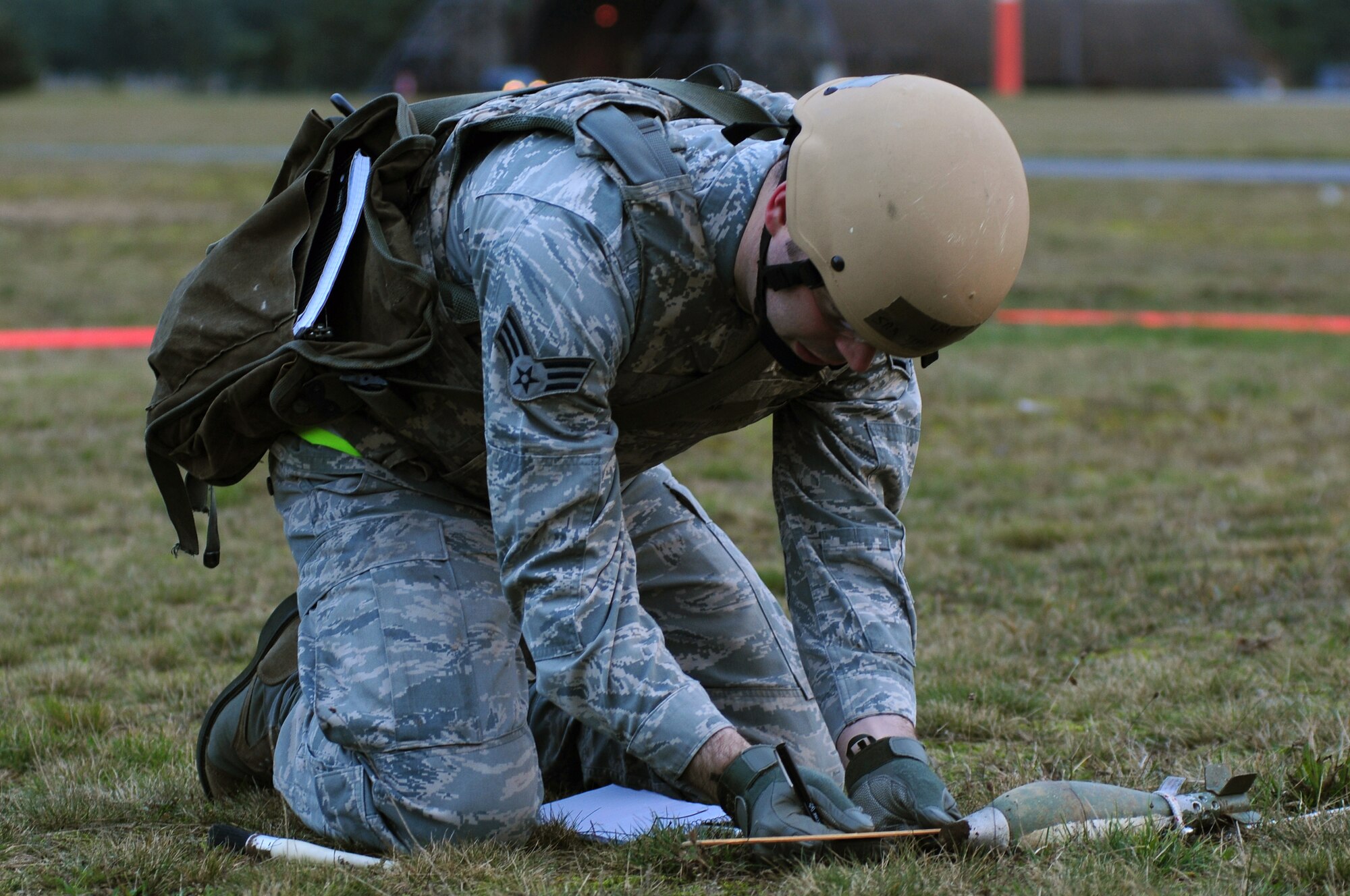 ROYAL AIR FORCE LAKENHEATH, England – Senior Airman Jeffrey Butera, 48th Civil Engineer Squadron explosive ordnance disposal technician, performs an initial inspection of an unexploded ordnance during a Phase II Exercise Dec. 5, 2012. The week-long exercise tested 48th Fighter Wing readiness to support NATO contingency operations. (U.S. Air Force photo by Airman 1st Class Cory D. Payne)