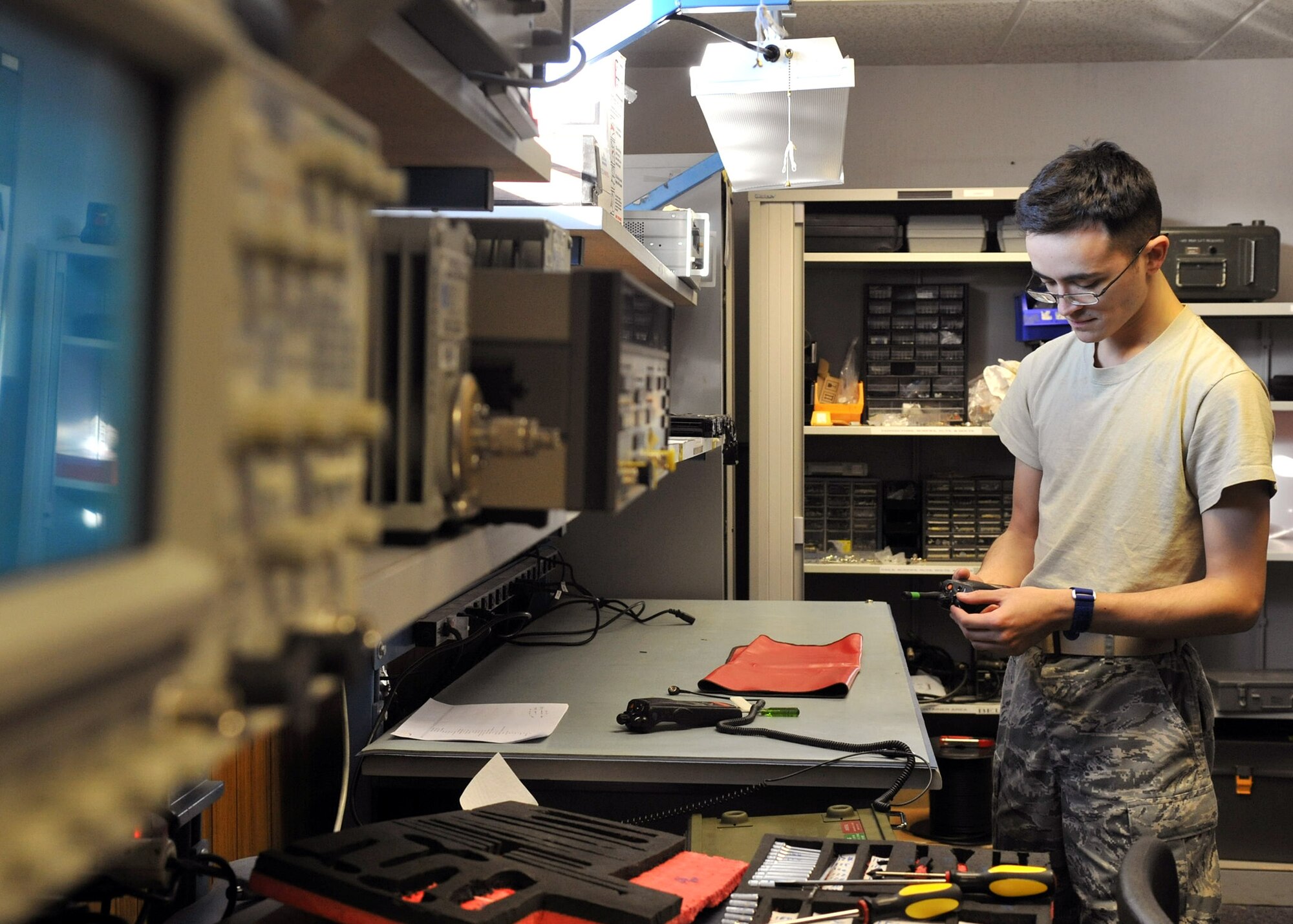 Senior Airman Nicholas Resley, 100th Communications Squadron transmissions system journeyman from Detroit, Mich., inspects a land mobile radio Dec. 5, 2012, at RAF Mildenhall, England. Airmen assigned to the transmissions systems section of the 100th CS are responsible for all radio communication and mass alert notification systems on base. (U.S. Air Force photo by Senior Airman Jerilyn Quintanilla/Released)