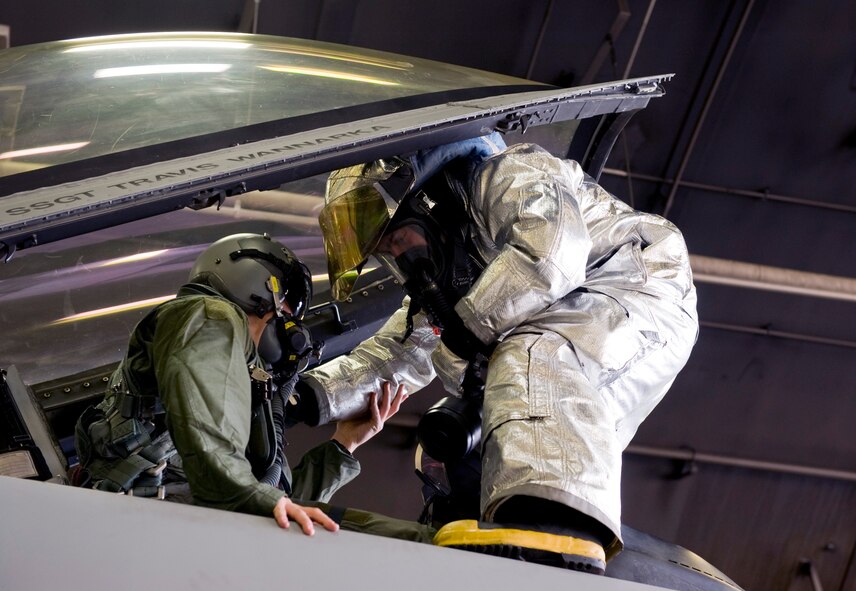 U.S. Air Force Senior Airman Seth Arbogast, 35th Civil Engineer Squadron rescue 5 crew chief firefighter, rescues a pilot at a simulated pilot egress training scenario, Dec. 5, 2012, during an Operational Readiness Exercise at Misawa Air Base, Japan. The training allows firefighters to safely rescue a pilot who cannot get out of the cockpit due to unconsciousness or other obstacles. The 35th Fighter Wing’s ORE tested the Airmen’s ability to operate in a contingency environment while facing multiple threats and bring stability to the Pacific region. (U.S. Air Force by Staff Sgt. Jess Lockoski)