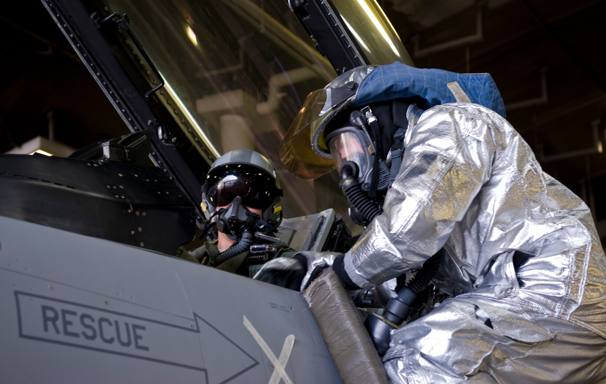 U.S. Air Force Senior Airman Seth Arbogast, 35th Civil Engineer Squadron rescue 5 crew chief firefighter, rescues a pilot at a simulated pilot egress training scenario, Dec. 5, 2012, during an Operational Readiness Exercise at Misawa Air Base, Japan. The training allows firefighters to safely rescue a pilot who cannot get out of the cockpit due to unconsciousness or other obstacles. The 35th Fighter Wing’s ORE tested the Airmen’s ability to operate in a contingency environment while facing multiple threats and bring stability to the Pacific region. (U.S. Air Force by Staff Sgt. Jess Lockoski)