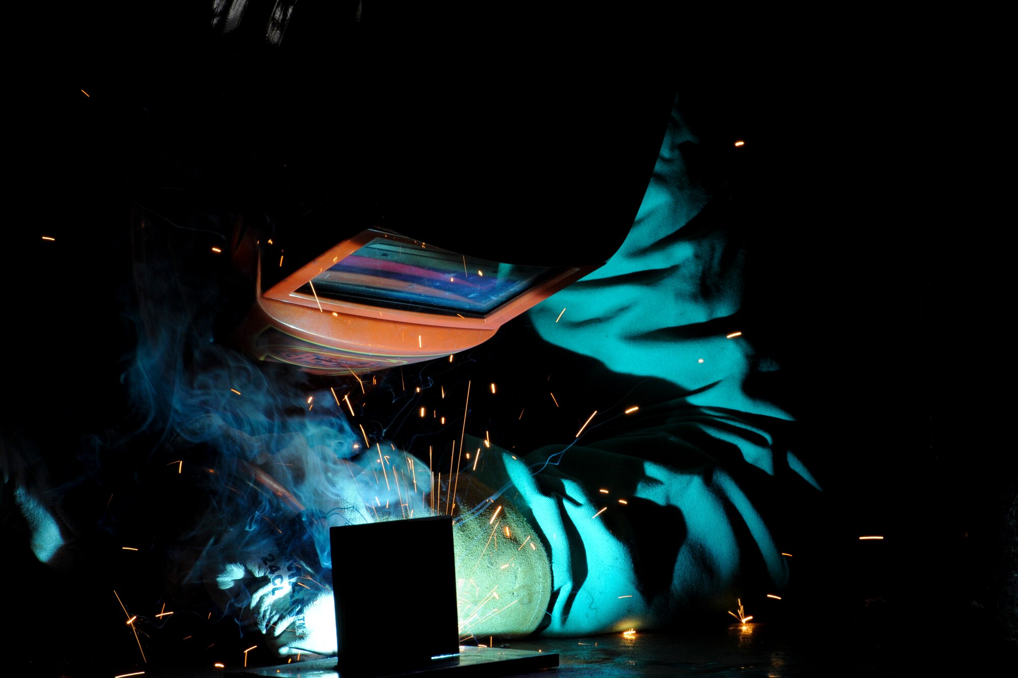 U.S. Air Force Col. Brian McDaniel, 18th Wing vice commander, performs a metal inert gas welding technique on Kadena Air Base, Japan, Dec. 6, 2012. During his visit to the 18th Equipment Maintenance Squadron, Airmen taught the commander how to do specific welding techniques. McDaniel said he wanted to learn how to weld because his father used to weld and would always boast about how good he was, so he wanted to try it out himself to show that he could do it too. (U.S. Air Force photo/Airman 1st Class Justin Veazie)