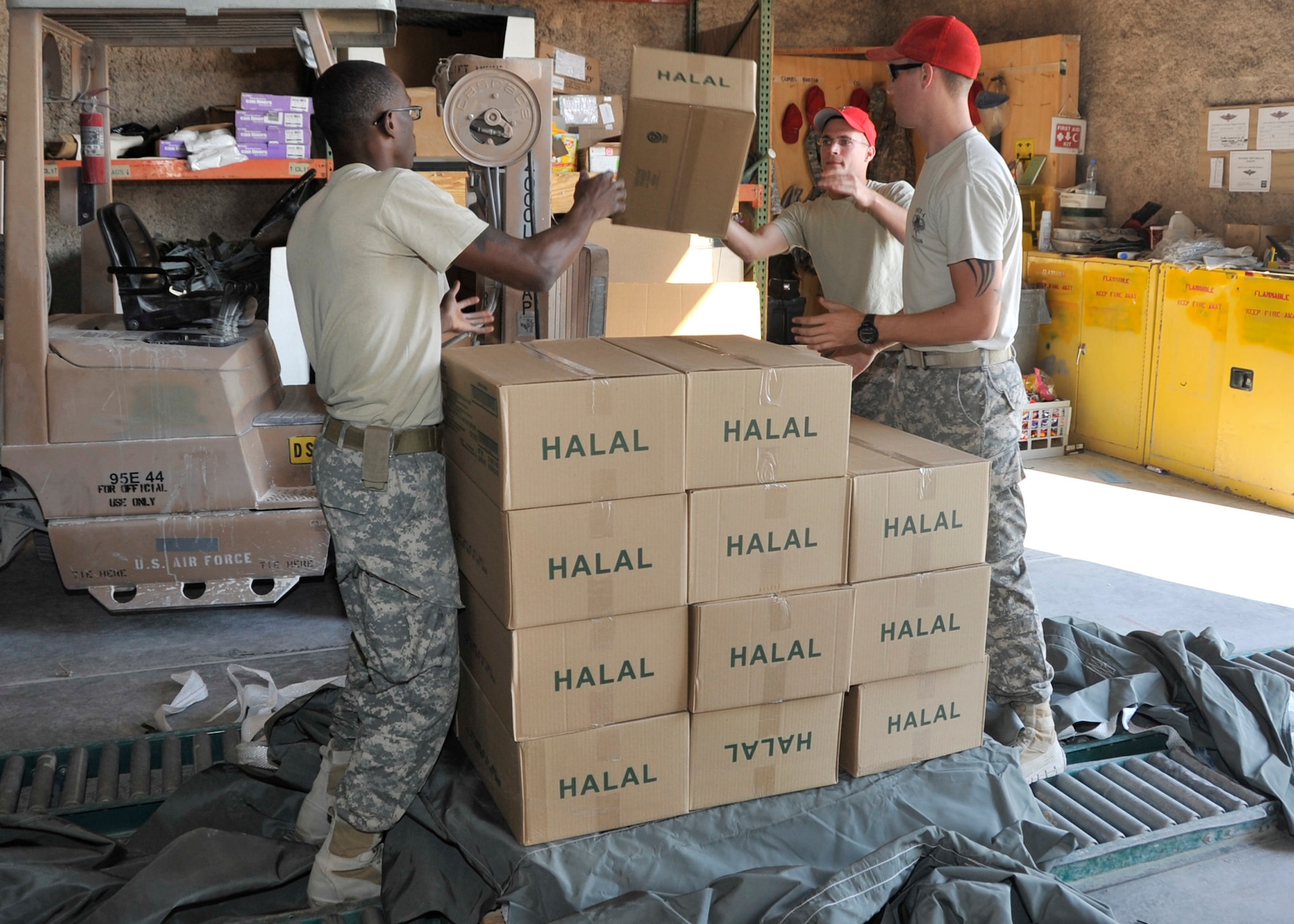 SOUTHWEST ASIA - Army Sgt. Barry MacDonald (middle), Spc. Neilon Burton (left) and Sgt. Jack Arnold prepare an airdrop load Dec. 4. They are assigned to the 421st Quartermaster Company Detachment 4, whose mission is to create and build airdrop loads to resupply ground troops in Afghanistan. MacDonald, a native of Nashville, Tenn., Burton, a native of the U.S. Virgin Islands, and Arnold, a native of Warner Robins, Ga., are all deployed from Fort Valley, Ga. (U.S. Air Force photo/Senior Airman Bryan Swink)