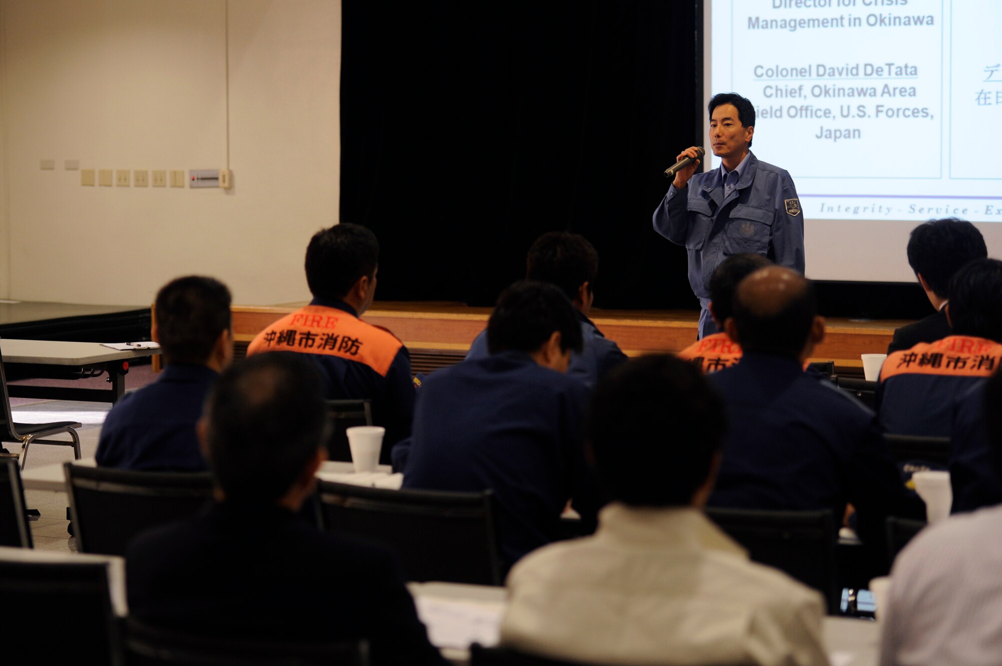 Cabinet Secretariat Hitoshi Tasaki, director for crisis management in Okinawa, gives opening remarks during the joint table-top exercise at the Schilling Community Center on Kadena Air Base, Japan, Dec. 4, 2012. Each of the U.S. military branches partner with members from Okinawan government agencies and emergency services for the periodic exercise to ensure the two countries work well together in the event of a U.S. military aircraft incident in the local community. The event was the eighth exercise based on a similar scenario between the U.S. military and Okinawan officials. (U.S. Air Force photo/Senior Airman Maeson L. Elleman/released)
