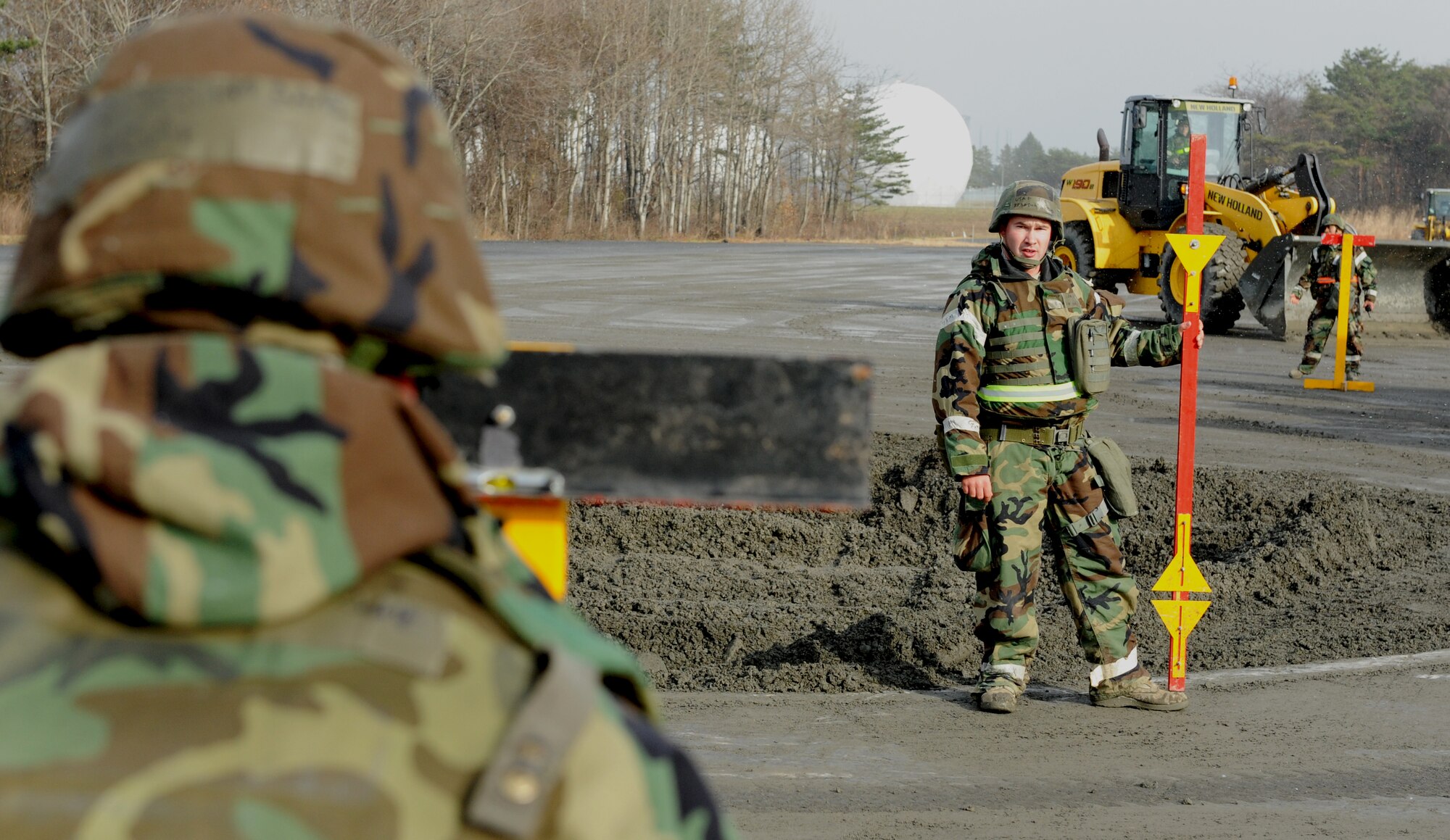 U.S. Air Force Senior Airman Brandon Hoptop, 35th Civil Engineer Squadron pavement and construction equipment operator, uses a stanchion and rod to measure the ground’s evenness for a  repair project, Dec. 5, 2012, during an Operation Readiness Exercise at Misawa Air Base, Japan. Faced with obstacles from simulated blasts, CES Airmen aimed to provide rapid repairs standard for three 50-foot craters within a four-hour time period. The 35th Fighter Wing’s ORE tested Airmen’s ability to operate in a contingency environment while facing multiple threats and bring stability to the Pacific region. (U.S. Air Force by Staff Sgt. Jess Lockoski) 