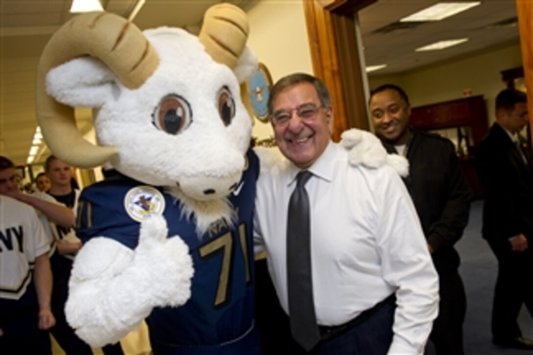 Secretary of Defense Leon E. Panetta poses for photos with Bill the Goat, the U.S. Naval Academy Midshipmen mascot, during a pep rally held in the halls of the Pentagon on Dec. 6, 2012.  The Naval Academy Midshipmen take on the West Point Black Knights in the 113th meeting between the two service schools at Philadelphia's Lincoln Financial Field on Saturday, Dec. 8th.  