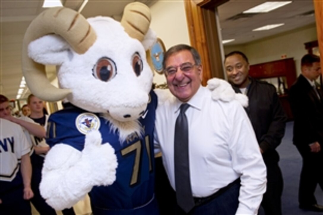 Defense Secretary Leon E. Panetta poses for a photo with Bill the Goat, the U.S. Naval Academy Midshipmen mascot, during a pep rally held in the halls of the Pentagon, Dec. 6, 2012, two days ahead of the historic Army-Navy college football game.
