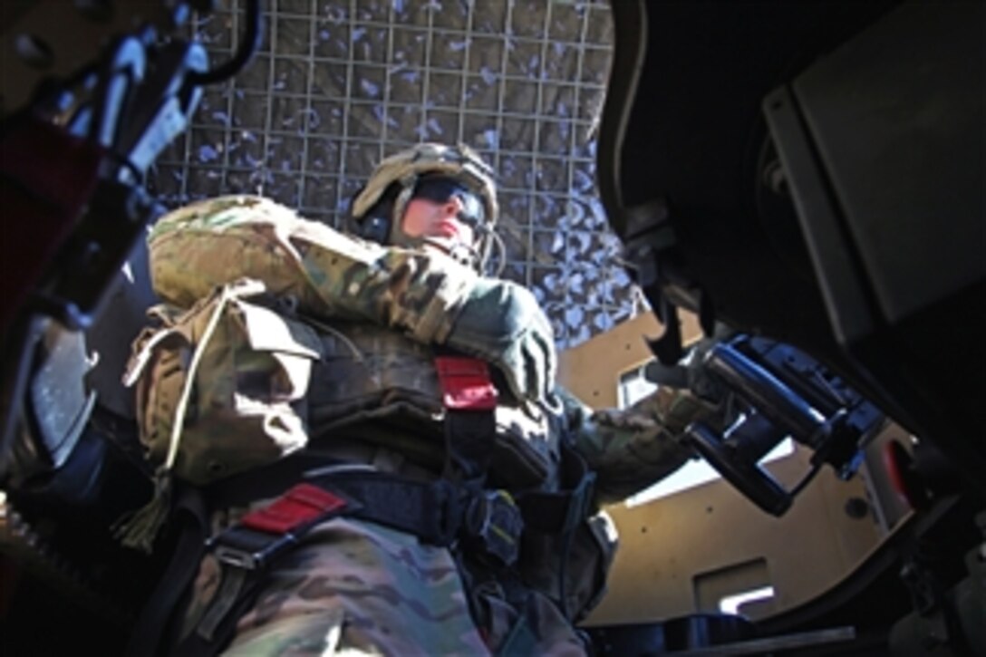 U.S. Army Spc. Aaron Hanson mans the gunner's turret of an armored vehicle during combat operations in Kotub Khel near Combat Out Post McClain in the Logar province of Afghanistan on Nov. 26, 2012.  Hanson is assigned to Bulldog Troop, 1st Squadron, 91st Calvary Regiment, 173rd (Airborne) Brigade Combat Team.  