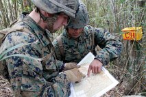 Lance Cpl. Andrew L. Elgin and Cpl. Chazz R. Peters verify their grid points during the land navigation course at the Jungle Warfare Training Center Nov. 28. Elgin is a military policeman with Headquarters and Service Battalion, Marine Corps Base Camp Butler, and Peters is a telephone systems personal computer repairer with Combat Logistics Regiment 35.