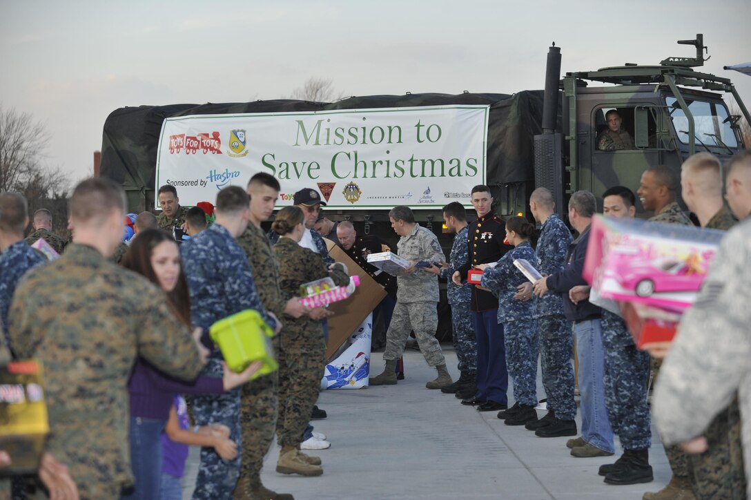 On a "Mission to Save Christmas" Marines from Marine Aircraft Group 49 along with other service members and volunteers off-load "Fat Albert", the Blue Angles C-130 Hercules, that flew in with a cargo bay full of toys collected by Marine Toys For Tots and donations by Toys R Us, Hasbro Inc., and Lockheed Martin for children in the Tri-State area affected by Super Storm Sandy Dec. 3, 2012, to the MAG 49's hangar at Joint Base McGuire-Dix-Lakehurst . The toys were then loaded into trucks to distribute throughout the region.