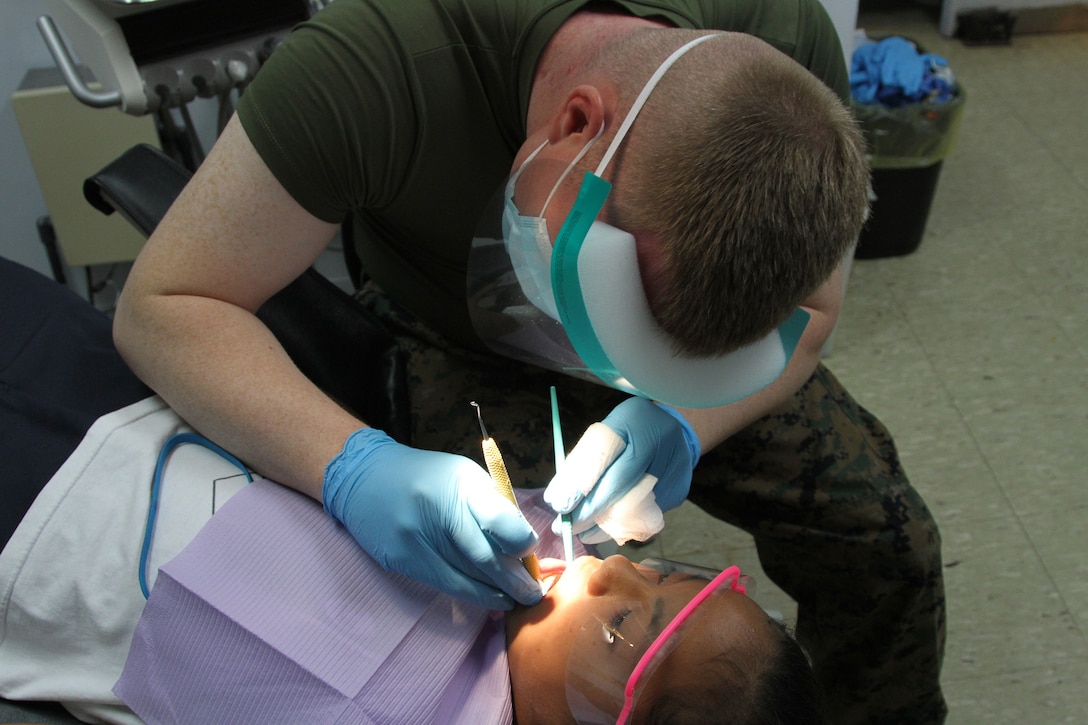 Victoria Sablan, 9, receives dental care from Seaman Jeffrey M. Ker at the Tinian Health Center Dec. 3. The Navy medical personnel will be on Tinian for the duration of Exercise Forager Fury 2012 to assist with the medical and dental needs of the local community. Sablanâ€™s twin brother, Victor, also received dental care in an adjacent room at the same time. Kerr is an oral surgical technician for 11th Dental Company, 3rd Dental Battalion, 3rd Marine Logistics Group, III Marine Expeditionary Force.