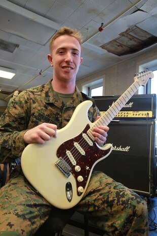 Cpl. Mark A. Boughton, a guitarist with the 2nd Marine Aircraft Wing Band, prepares to put his guitar away after practicing for the 2012 Christmas Concert Dec. 3.


