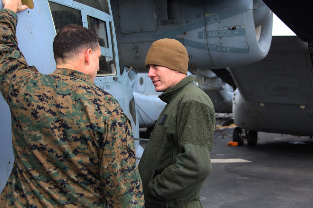 USS IWO JIMA, Mediterranean Sea (Dec. 6, 2012) - Col. Francis Donovan, commanding officer, 24th Marine Expeditionary Unit, discusses the maintenance of an MV-22B Osprey with Cpl. Robert Parks, a Marine with Marine Medium Tiltrotor Squadron 261 (Reinforced), 24th Marine Expeditionary Unit, while transiting through the Strait of Gibraltar aboard USS Iwo Jima, Dec. 6, 2012. The 24th MEU is deployed with the Iwo Jima Amphibious Ready Group and is currently in the 6th Fleet area of responsibility. Since deploying in March, they have supported a variety of missions in the U.S. Central, Africa and European Commands, assisted the Navy in safeguarding sea lanes, and conducted various bilateral and unilateral training events in several countries in the Middle East and Africa. (U.S. Marine Corps photo by Lance Cpl. Tucker S. Wolf/Released)