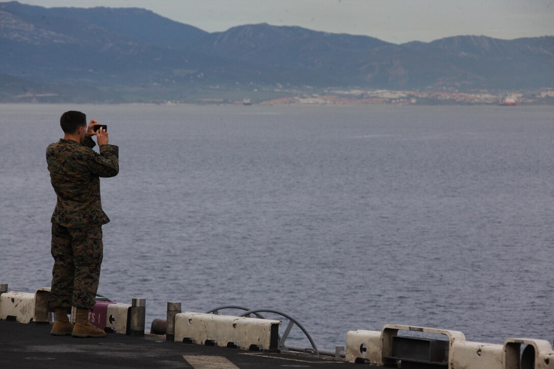USS IWO JIMA, Mediterranean Sea (Dec. 6, 2012) - 1st Lt. Michael Bohac, a platoon commander with Bravo Co., Battalion Landing Team 1st Battalion, 2nd Marine Regiment, 24th Marine Expeditionary Unit, takes pictures while transiting through the Strait of Gibraltar aboard USS Iwo Jima, Dec. 6, 2012. The 24th MEU is deployed with the Iwo Jima Amphibious Ready Group and is currently in the 6th Fleet area of responsibility. Since deploying in March, they have supported a variety of missions in the U.S. Central, Africa and European Commands, assisted the Navy in safeguarding sea lanes, and conducted various bilateral and unilateral training events in several countries in the Middle East and Africa. (U.S. Marine Corps photo by Lance Cpl. Tucker S. Wolf/Released)