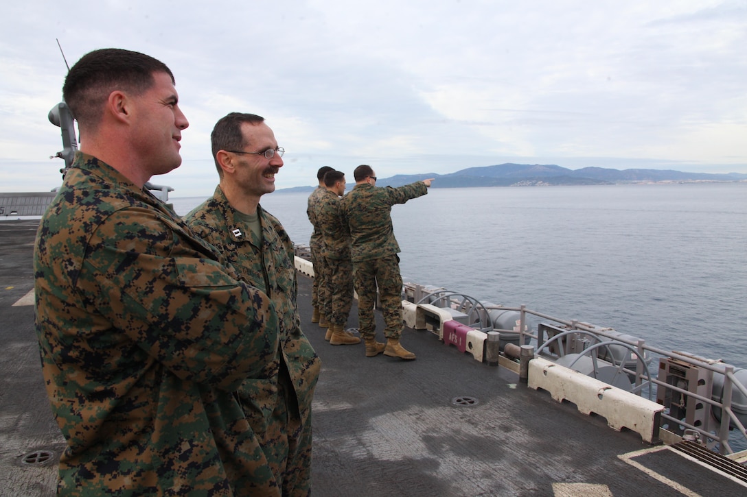 USS IWO JIMA, Mediterranean Sea (Dec. 6, 2012) - Staff Sgt. Canon Richard, front, and Navy Lt. Randy Gibson, both with the 24th Marine Expeditionary Unit, enjoy the view of the coastline while transiting through the Strait of Gibraltar aboard USS Iwo Jima, Dec. 6, 2012. The 24th MEU is deployed with the Iwo Jima Amphibious Ready Group and is currently in the 6th Fleet area of responsibility. Since deploying in March, they have supported a variety of missions in the U.S. Central, Africa and European Commands, assisted the Navy in safeguarding sea lanes, and conducted various bilateral and unilateral training events in several countries in the Middle East and Africa. (U.S. Marine Corps photo by Lance Cpl. Tucker S. Wolf/Released)