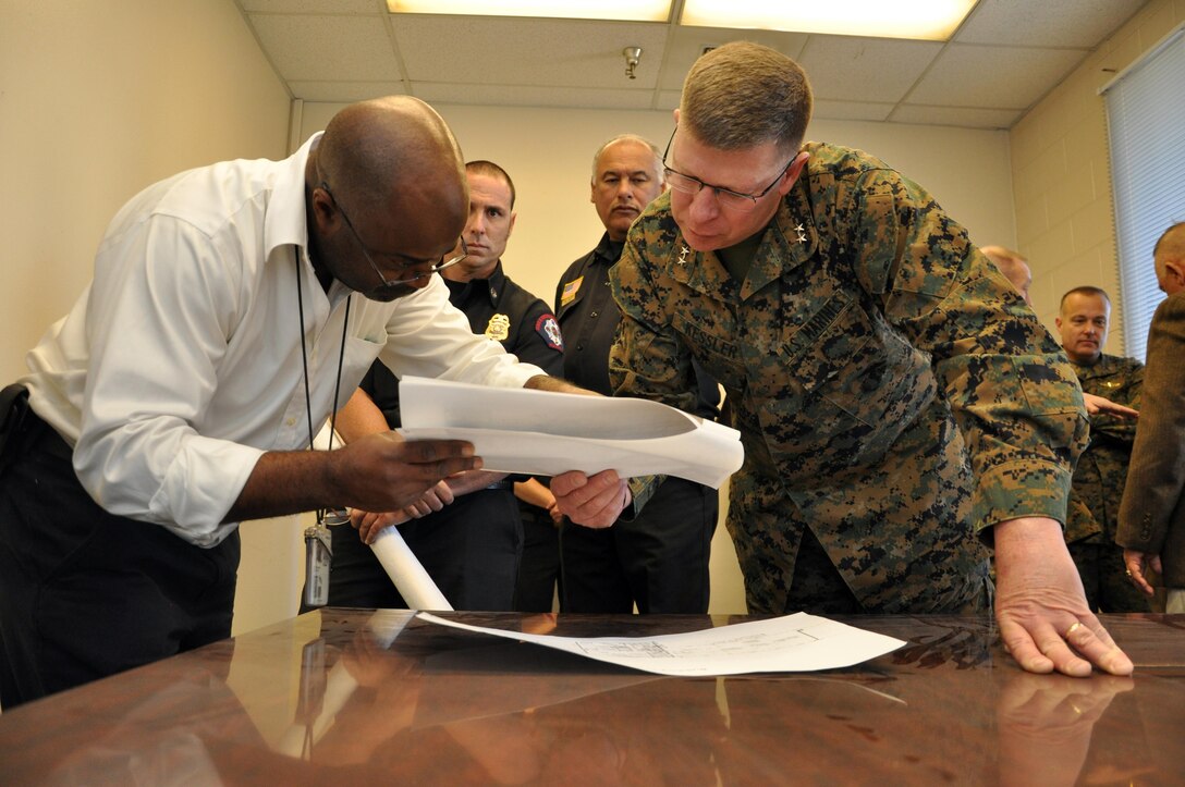 Major General James Kessler, commanding general of Marine Corps Installations Command (right) looks at drafting plans of
 an upcoming MILCON project with Keith D. Kirkland, base planner with MCLB Barstow's Public Works Department.
 During his visit, Dec. 6, Gen. Kessler received indepth briefs on MCLB Barstow's Energy and Environmental Programs. 


