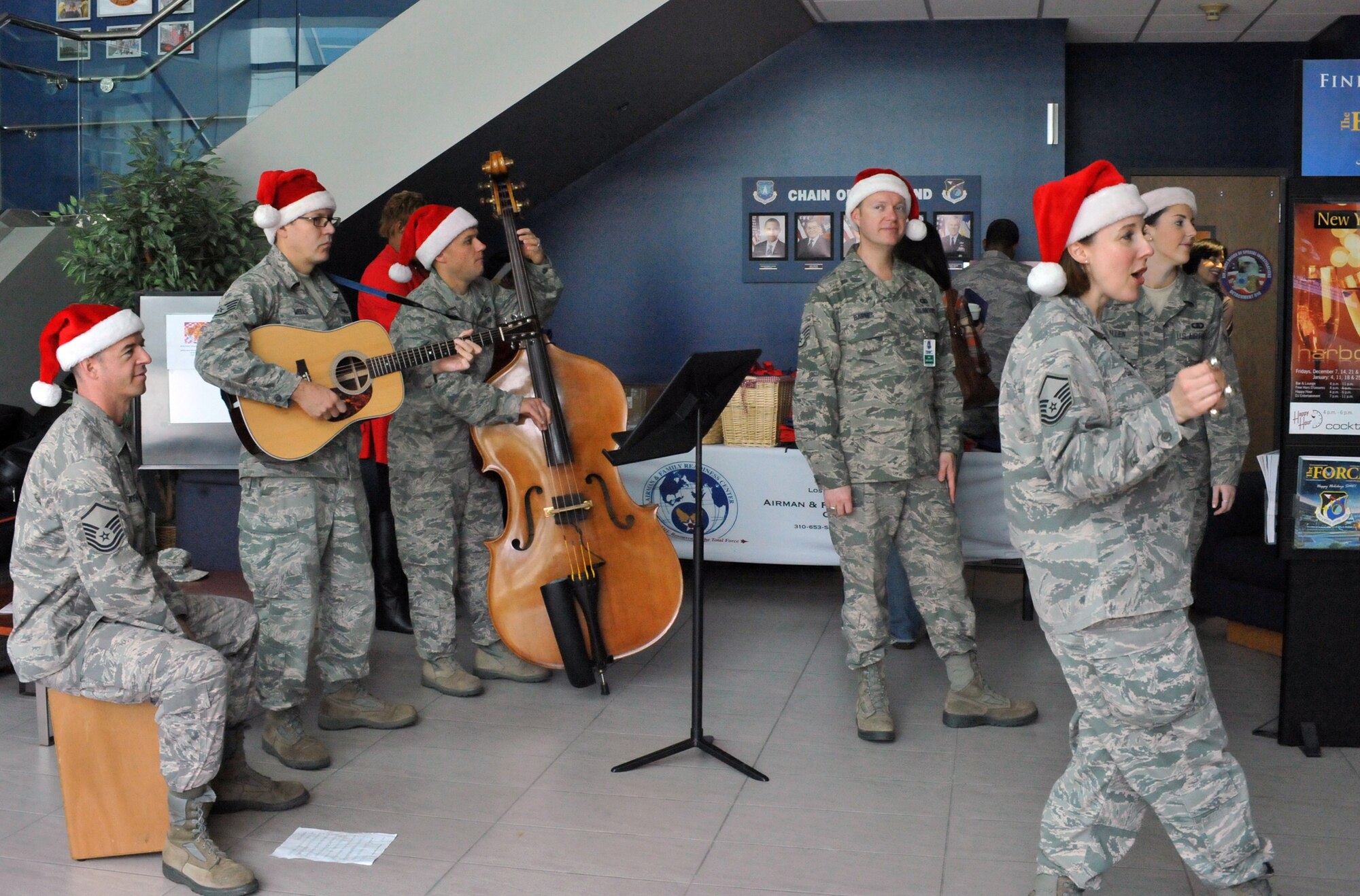 Holiday carolers from the Band of the Golden West perform here during the group’s annual holiday tour of installations in their operating area, Dec. 7. (Photo by Sarah Corrice)