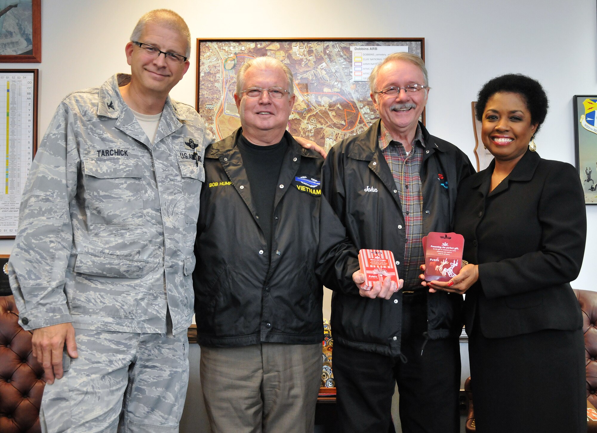 Members of the Georgia Vietnam Veterans Alliance presented Col. Timothy Tarchick, 94th Airlift Wing commander, and Angela Pedersen, 94th AW Airman and Family Readiness Office director, with 40 gift cards to a local grocery store. The gift cards will be used to help, not only Airmen, but also Marines, Soldiers and Sailors around Dobbins Air Reserve Base in need during the holiday season. (U.S. Air Force photo/Senior Airman Elizabeth Van Patten)