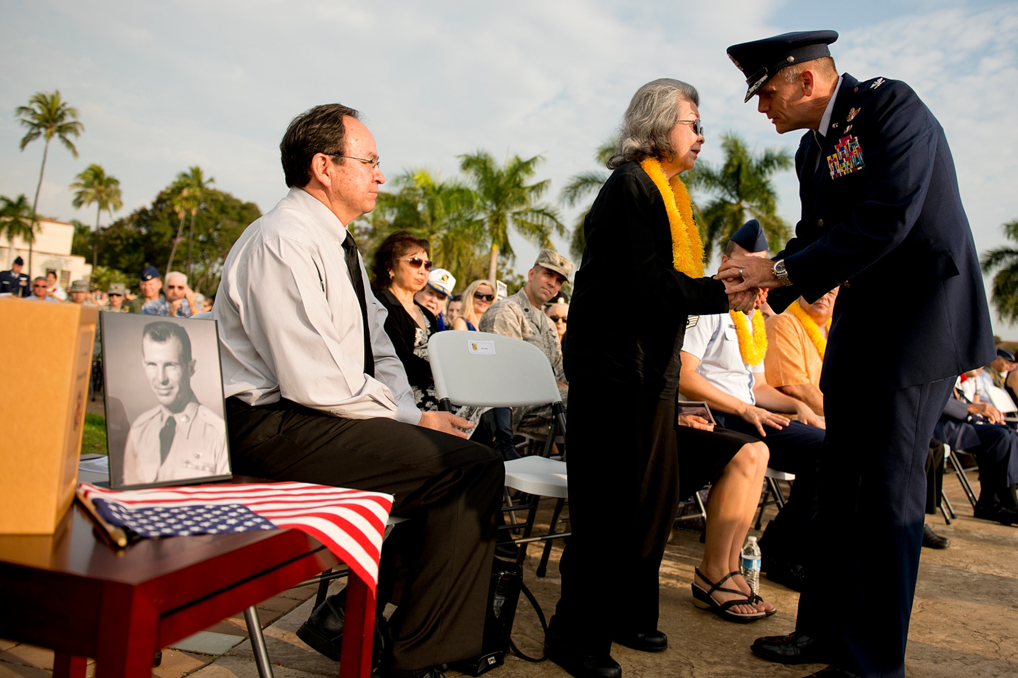 Col. Johnny Roscoe, 15th Wing commander, honors Elizabeth Chew, widow of Senior Master Sgt. (Ret.) Raymond Perry, during the 71st anniversary remembrance ceremony on Joint Base Pearl Harbor-Hickam, Dec. 7, 2012. Perry, a survivor of the attacks, went on to serve 26-years in the Air Force and was a founding member of the pararescue career field. After the ceremony, the family and friends of Perry scattered his ashes in the waters of Pearl Harbor during a private ceremony.  (U.S. Air Force photo/Staff Sgt. Mike Meares)