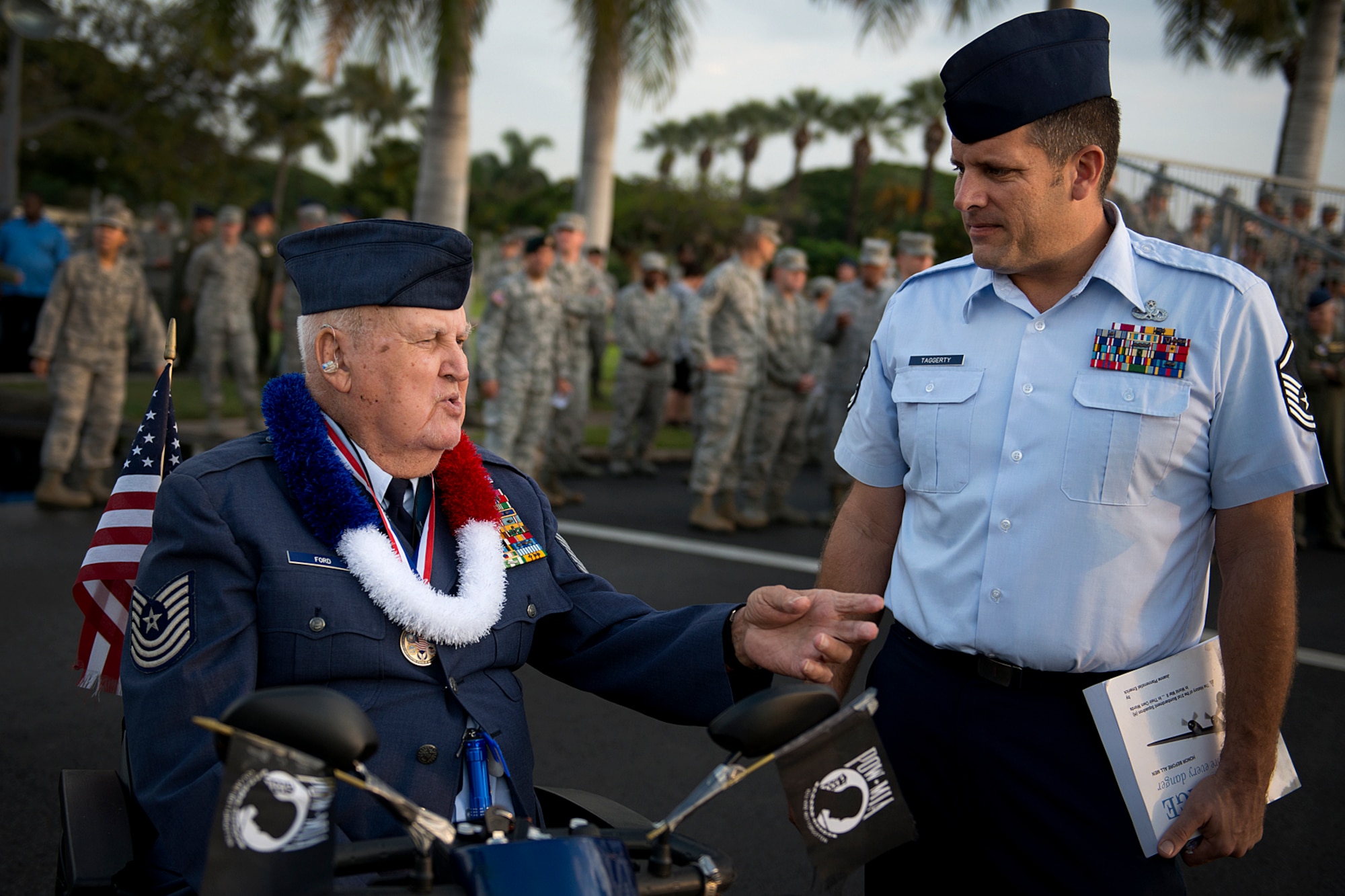 Master Sgt. (Ret.) Ken Ford, a Hickam Field survivor of the Dec. 7, 1941, attacks, speaks with Master Sgt. Kevin Taggerty, 735th Aircraft Maintenance Squadron, about his experience on a few yards away from where he was when the Japanese began their attacks on the island. The remembrance ceremony hailed and commemorated the actions of the service members and civilians that responded to the attacks, many giving their lives in the line of fire for their country. Hickam Filed lost 189 Airmen and civilians while more than 300 were wounded. Ford served in WWII, Korea War and in Vietnam during his 26-year military career. (U.S. Air Force photo/Staff Sgt. Mike Meares)