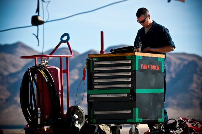 U.S. Air Force Staff Sgt. Carl Engle, 757th Aircraft Maintenance Squadron crew chief, looks over a technical order log during the Mission Employment Phase exercise Dec. 7, 2012, at Nellis Air Force Base, Nev. The ME Phase exercise incorporates Air Force capabilities in diverse scenarios to include aircraft in conjunction with space and cyberspace assets. (U.S. Air Force photo/Senior Airman Brett Clashman)