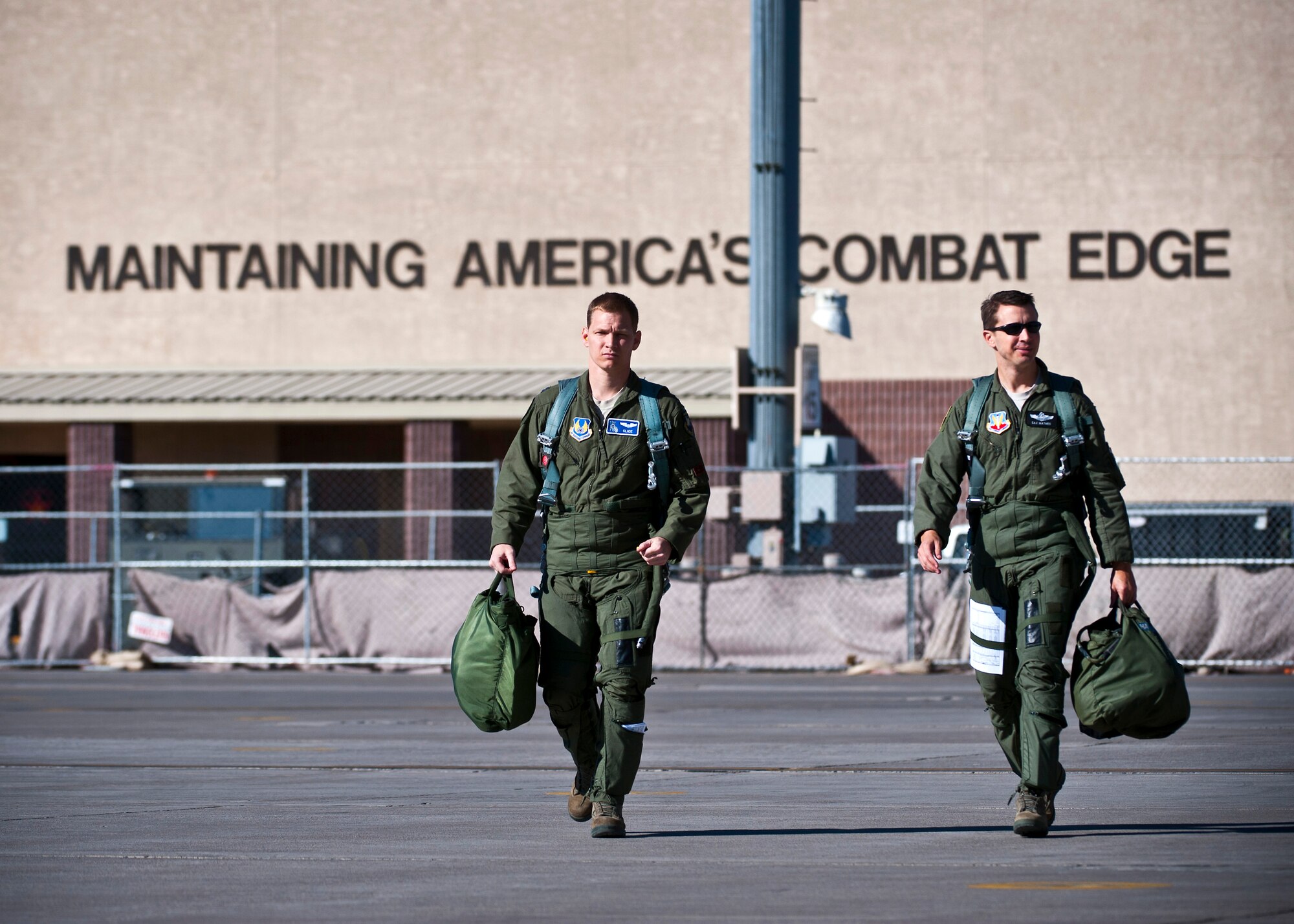 U.S. Air Force Capt. Jaxon Lee, 414th Combat Training Squadron F-15 Eagle pilot, and Lt. Col. Marc Mathes, 53rd Test and Evaluation Group deputy commander, step towards their aircraft during the Mission Employment Phase exercise Dec. 7, 2012, at Nellis Air Force Base, Nev. The ME Phase, conducted in the Nevada Test and Training Range, is the capstone exercise conducted by the U.S. Air Force Weapons School. (U.S. Air Force photo/Senior Airman Brett Clashman)