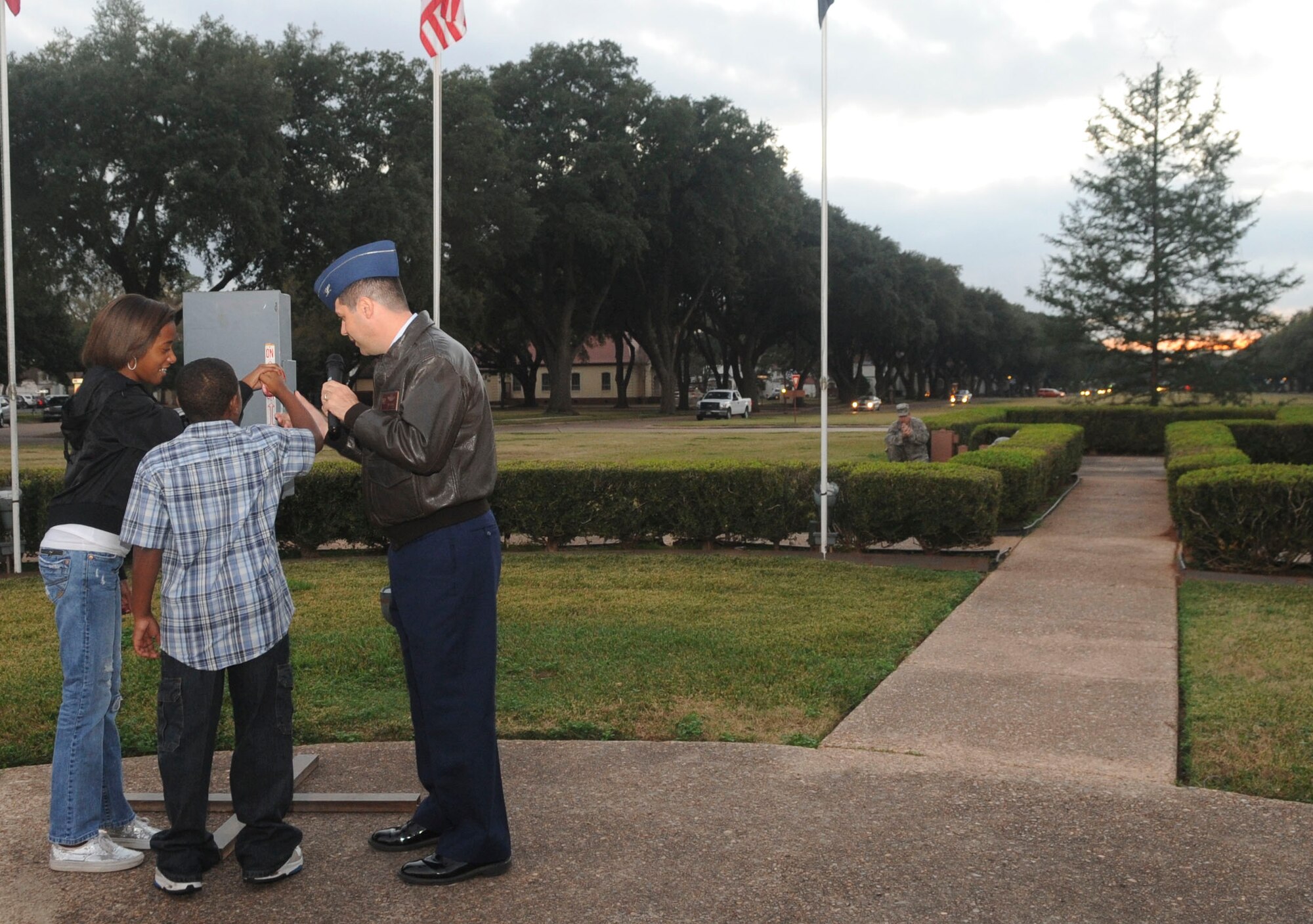 A deployed member's children help Col. Andrew Gebara, 2nd Bomb Wing commander, turn on the switch for the annual Holiday tree lighting ceremony on Barksdale Air Force Base, La., Dec. 6. More than 100 members of Team Barksdale gathered to watch the lighting ceremony and visit with Santa. (U.S. Air Force photo/Senior Airman Kristin High)
